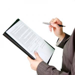 Businessperson holding clipboard and pen