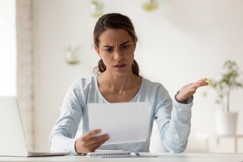 Annoyed woman looking at contract